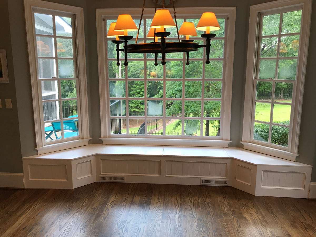 Photo of a Traditional Style bay window seat with front vents in front of a large bay window in a customer's home