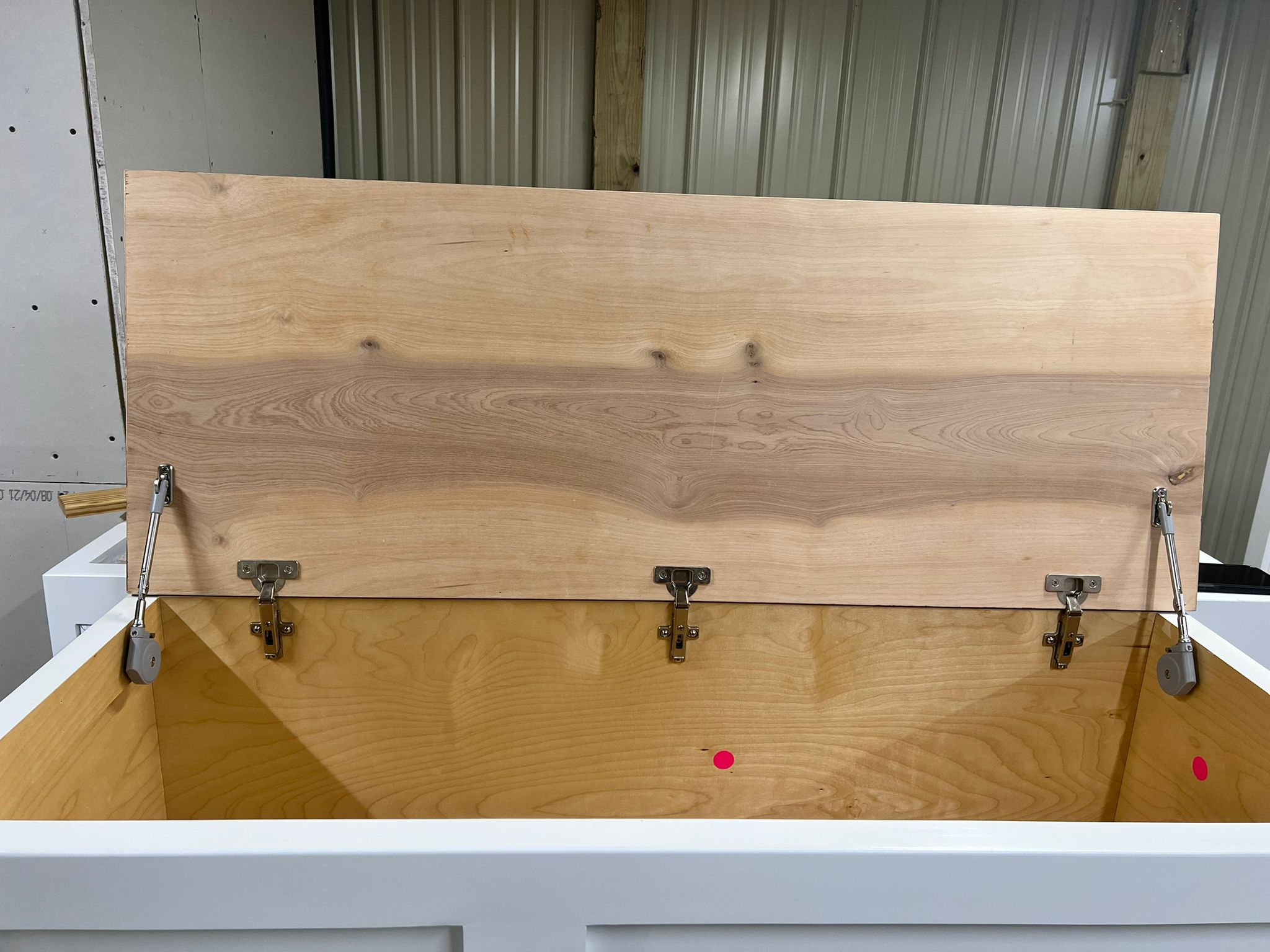 Photo of a Shaker style straight bench with open lid so you can see soft close hinges in addition to traditional hinges