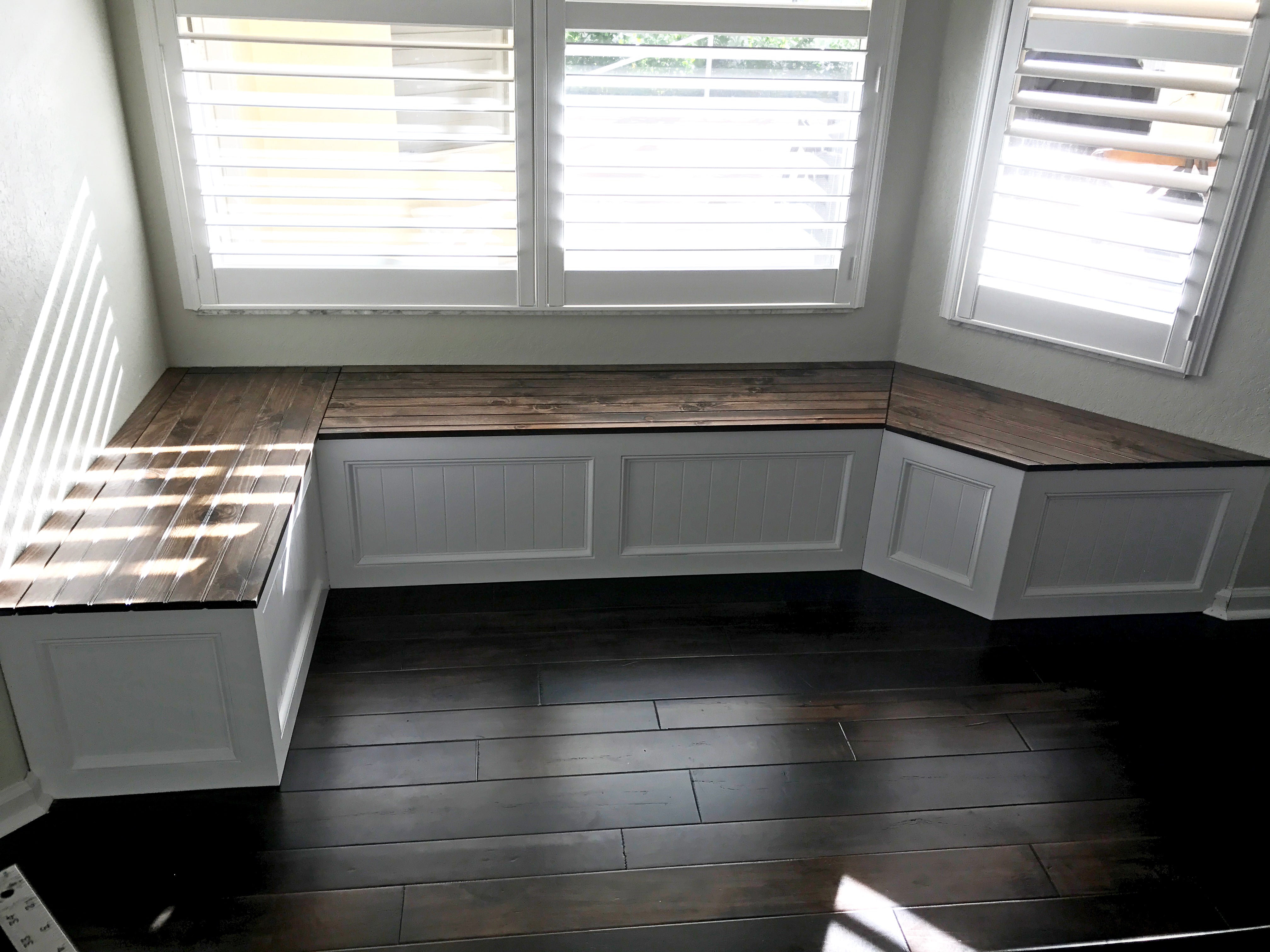 Photo of a window seat with a custom right angle on one side and a traditional window seat angle on the other side