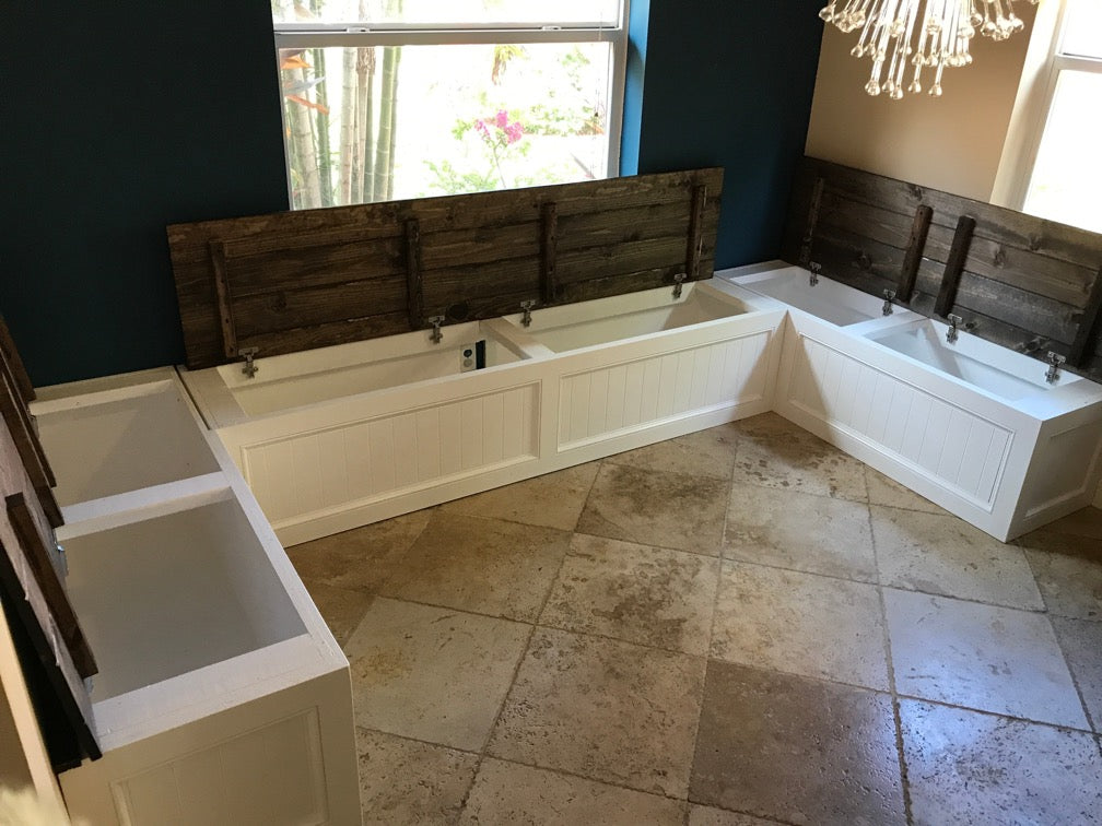 Photo of a Traditional style U-shape bench painted white with all tops open to show storage space.