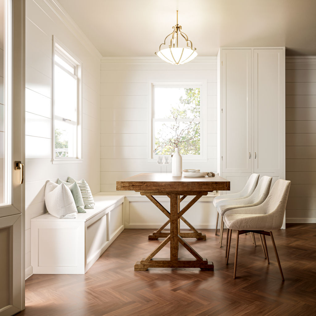 L-shaped white shaker-style bench with hidden storage and open end shelves, placed under a window in a farmhouse-style room.