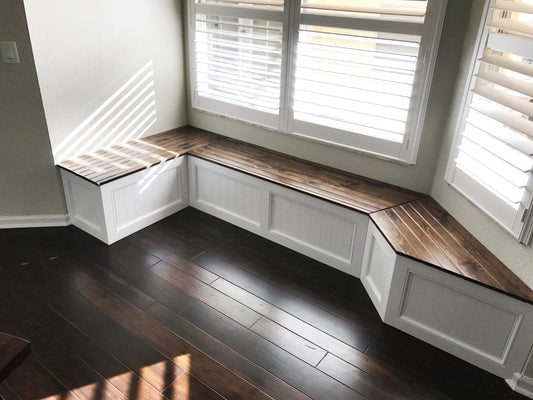 Photo of a window seat with a custom right angle on one side and a traditional window seat angle on the other side