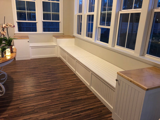 Photo of a Traditional style L-shape corner bench with custom raised end tables in front of a wall of windows